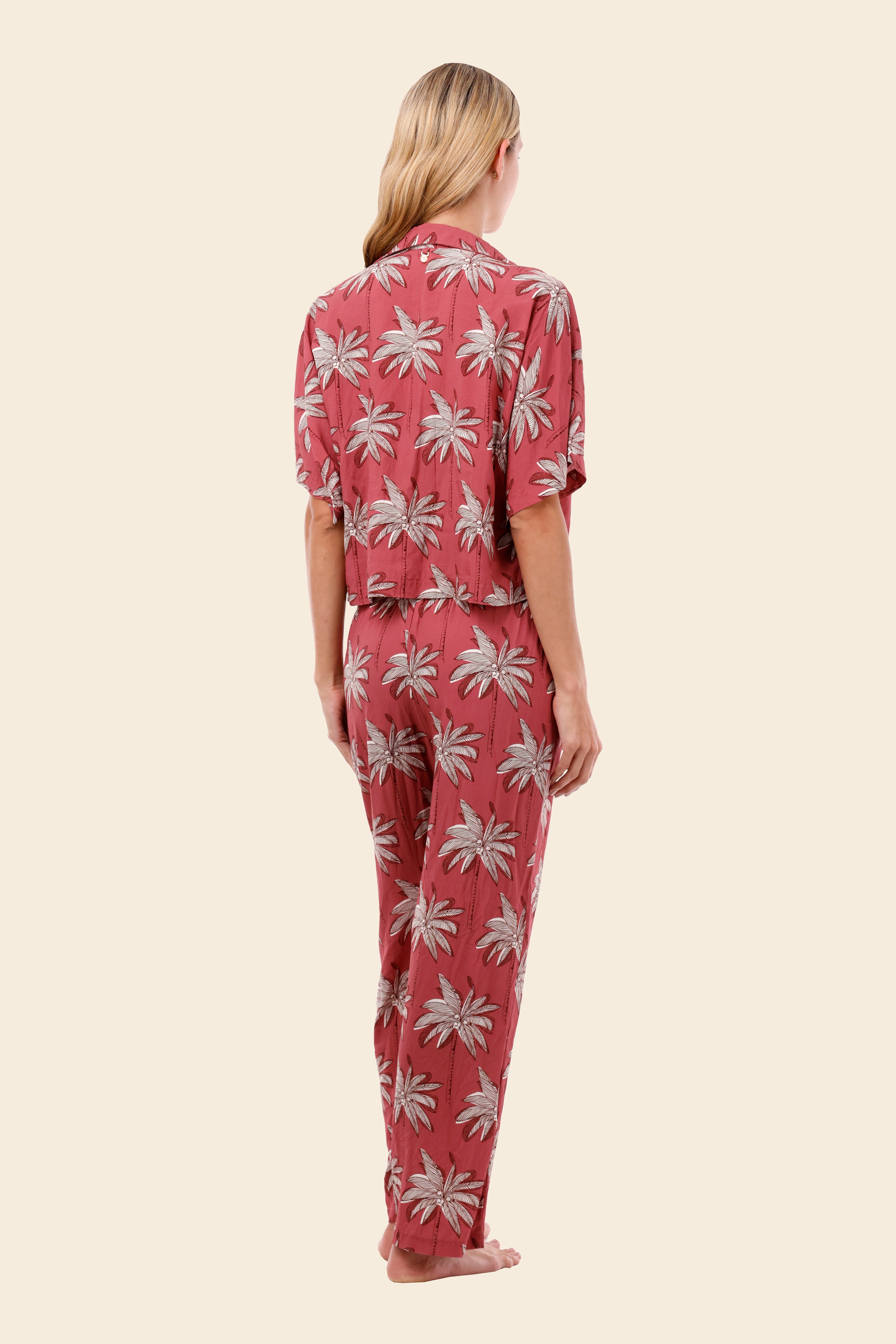 Woman wearing a pink floral womens resort wear