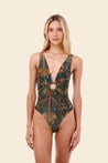Woman wearing a patterned one-piece swimsuit 