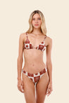 Woman wearing a red and white patterned bikini 